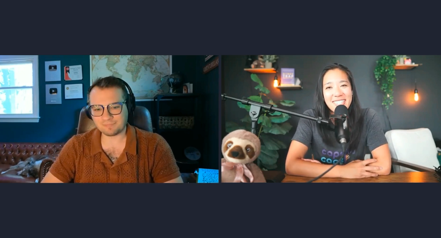 Split-screen video interview still showing guest Austin Armstrong on the left, with YouTube play-button plaques on the wall behind him, and host Deirdre Tshien on the right